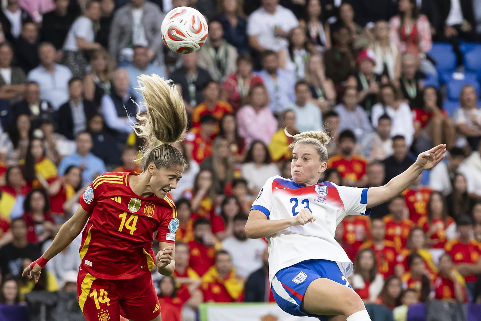 England's Alessia Russo, right, scores past Spain's Laia Aleixandri, left, during the Women's Euro 2025 final soccer match between England and Spain at St. Jakob-Park in Basel, Switzerland, Sunday, July 27, 2025. (Jean-Christophe Bott/Keystone via AP)
