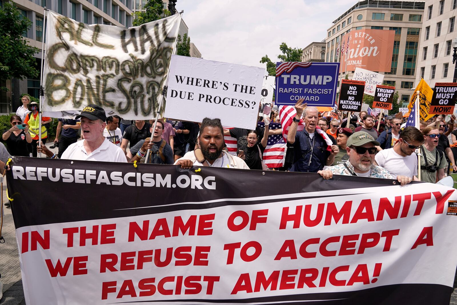 Demonstrators rally near Lafayette Park during a demonstration against President Donald Trump policies in Washington, Saturday, June 14, 2025. (AP Photo/Jose Luis Magana)