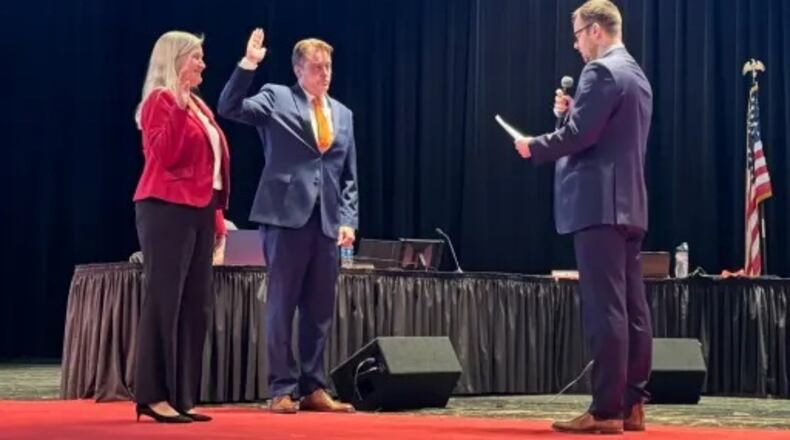 Lakota Schools Treasurer Adam Zink, right, swears in new Lakota Board of Education President Julie Shaffer and newly elected board member Doug Horten during a recent, first meeting of school board in 2024. Local school boards that help oversee millions of dollars of taxpayer funds spent on the operations of public school recently conducted the annual process of voting on presidents and vice presidents of their governing bodies. CONTRIBUTED