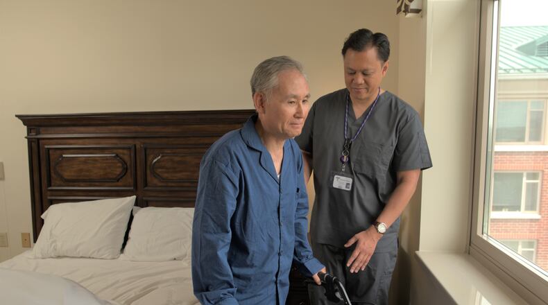 A direct care worker helps a patient in his home. COURTESY OF THE ALZHEIMER'S ASSOCIATION