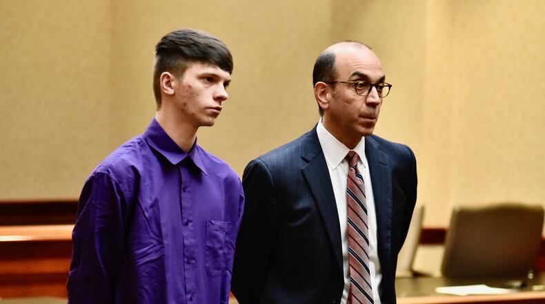 Logan Henry, left, with attorney Edward Perry, in Buter County Common Pleas Court Thursday. Henry is charged with arson for allegedly setting a fire last summer that caused huge fire at a Hamilton warehouse NICK GRAHAM/STAFF