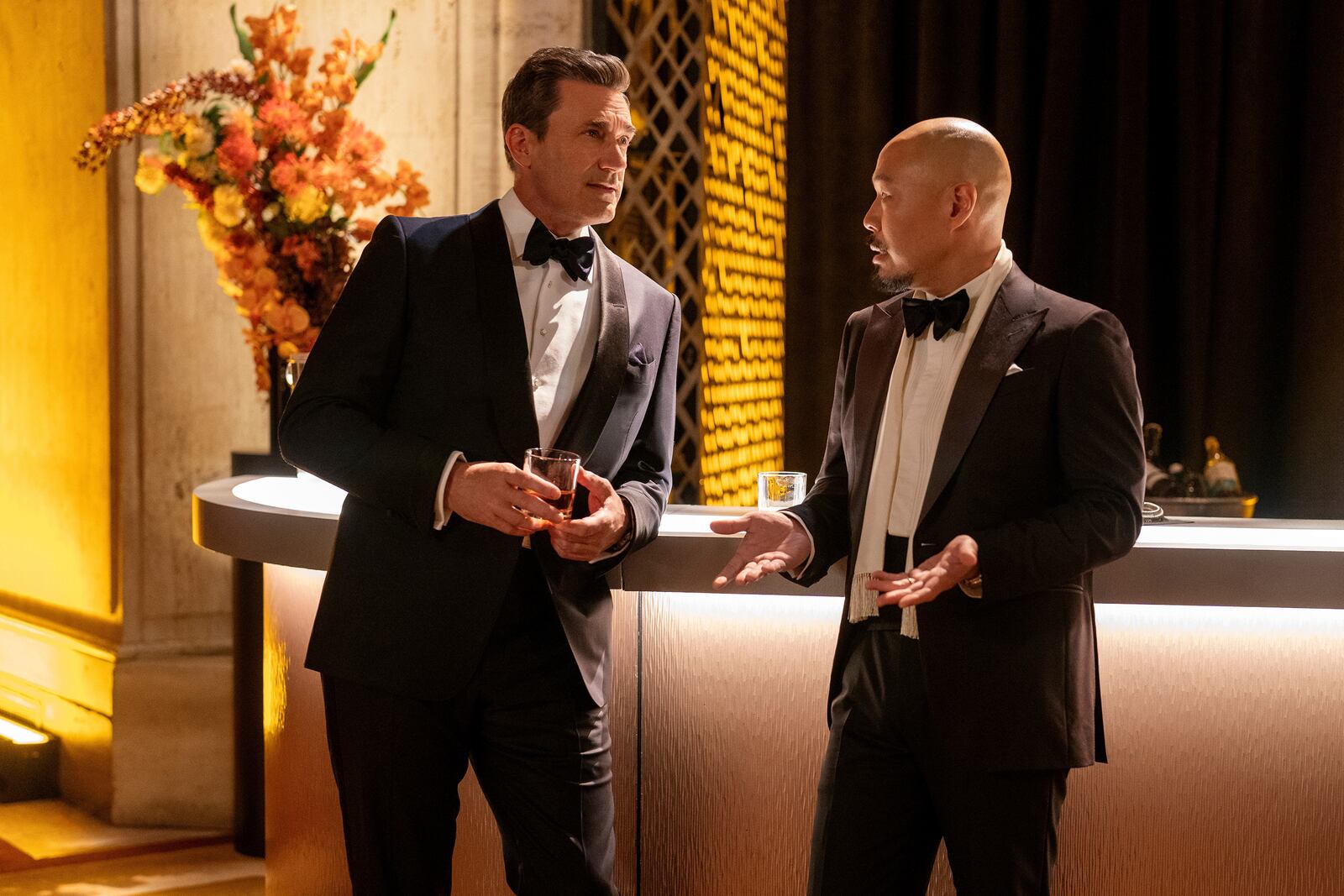 This image released by Apple TV+ shows Jon Hamm, left, and Hoon Lee in a scene from "Your Friends & Neighbors." (Jessica Kourkounis/Apple TV+ via AP)