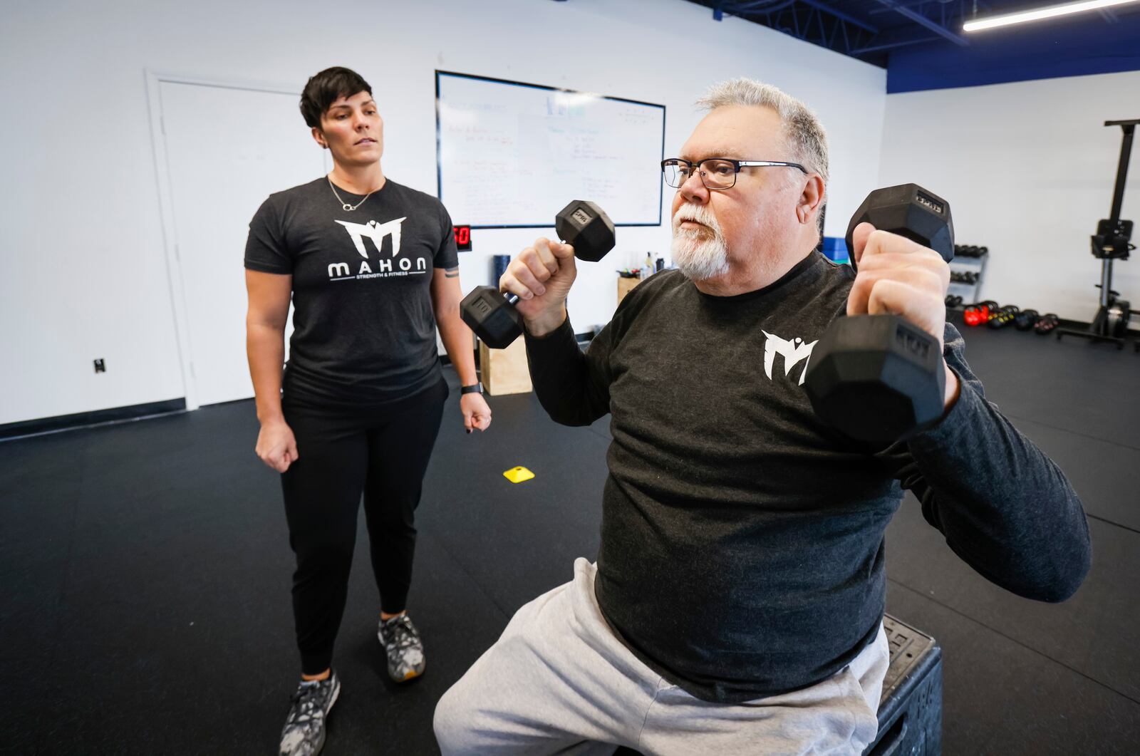 Bryan Watkins works with Mimi Mahon at Mahon Strength and Fitness on Brookwood Ave. in Hamilton Jan. 18, 2022. Mahon, donated a kidney to an exchange program when her mom needed a kidney. Watkins is trying to get in better shape with increase mobility while he waits for kidney tansplant. NICK GRAHAM / STAFF