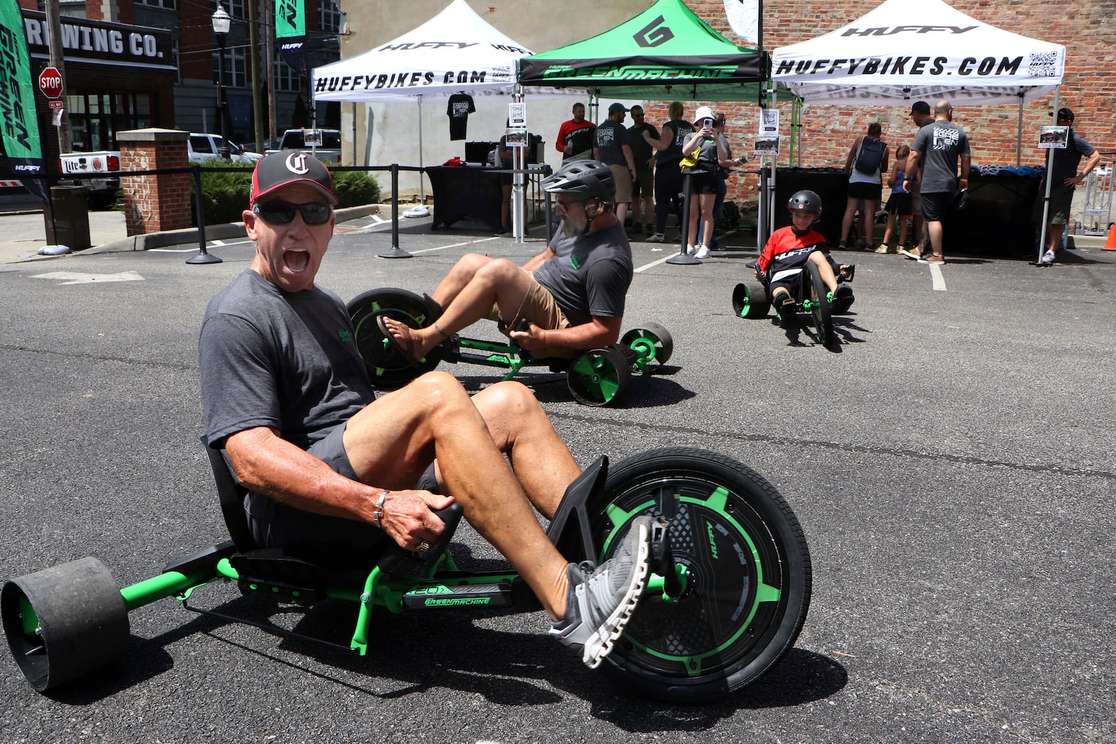 IMAGE DISTRIBUTED FOR HUFFY BICYCLES - Former Cincinnati Reds baseball player Doug Flynn test rides the new Huffy Green Machine at the Danger Wheel downhill race on Saturday, July 29, 2023 in Cincinnati. The annual "downhill Big Wheel race for adults" benefits the beautification of the Pendleton neighborhood in Cincinnati and served as the national launch for the new Huffy Green Machine. (Tom Uhlman/AP Images for Huffy Bicycles)