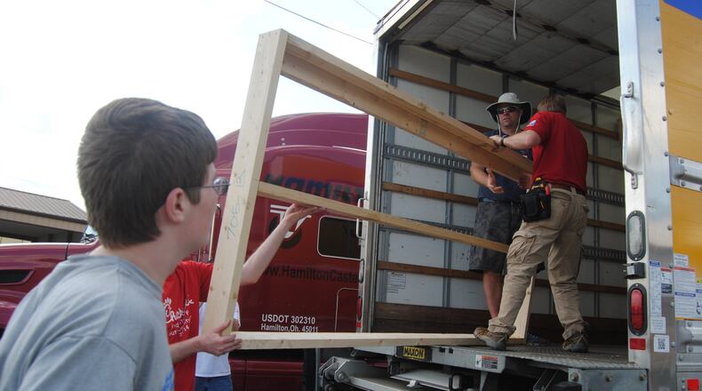 Volunteers from Hamilton Caster and Chick-fil-A in Fairfield Twp. team up Sunday, May 14, 2017, behind the Hamilton manufacturing company’s facility to construct the walls of a house Habitat for Humanity. Loaded into a truck, the 62 walls will next go to Price Hill, where Habitat for Humanity volunteers will use them to construct a home in three days. ERIC SCHWARTZBERG/STAFF