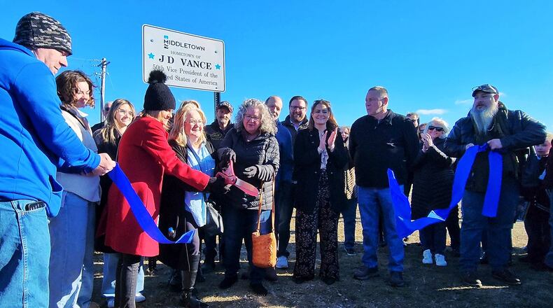 Beverly Aikins, mother of Vice President JD Vance, cuts the ribbon for the newly installed signs recognizing Vance Saturday, Feb. 1, 2025 in his hometown of Middletown. NICK GRAHAM/STAFF