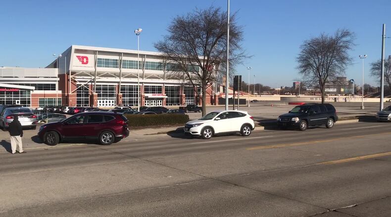 Vehicles lined up on Edwin C. Moses Boulevard outside University of Dayton Arena for a drive-thru vaccine clinic on Thursday, Jan. 21, 2021. STAFF/JIM NOELKER