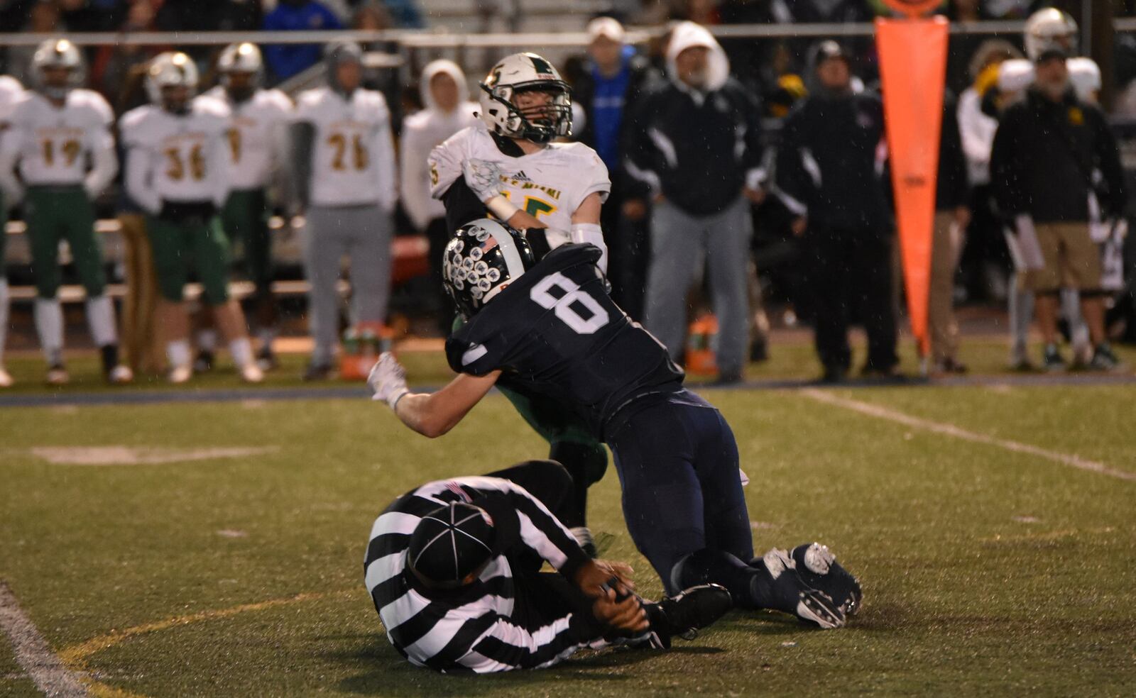 An official can’t quite get out of the way on a play by Edgewood’s Justin Hiltbrand (8) during Friday night’s Division II, Region 8 playoff game against Little Miami at Kumler Field in St. Clair Township. The visiting Panthers won 10-7. CONTRIBUTED PHOTO BY DAWN JOSEPH