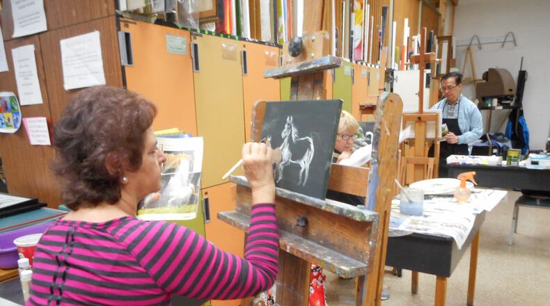 Middletown Arts Center student Stefanie Darbyshire works on her latest painting. Many of MAC s artists have donated work for this year’s auction. CONTRIBUTED