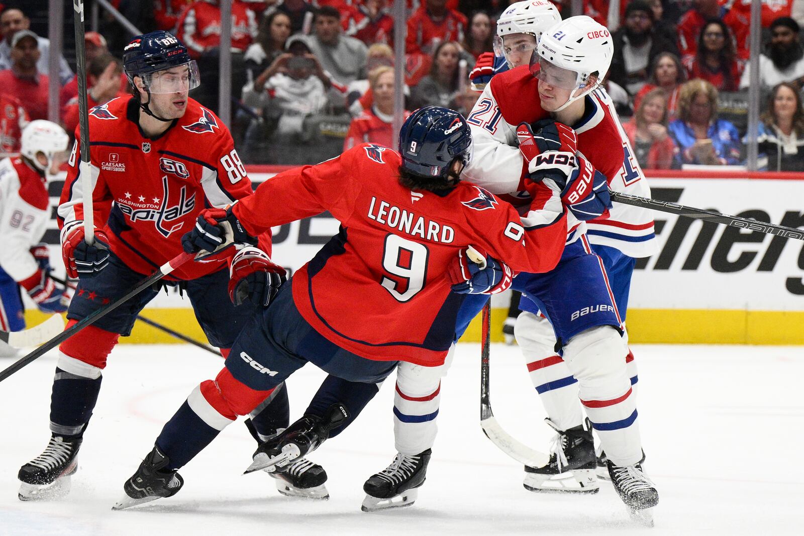 Montreal Canadiens defenseman Kaiden Guhle (21) brings down Washington Capitals right wing Ryan Leonard (9) in the first period of Game 1 of a first-round NHL hockey playoff series Monday, April 21, 2025, in Washington. (AP Photo/Nick Wass)