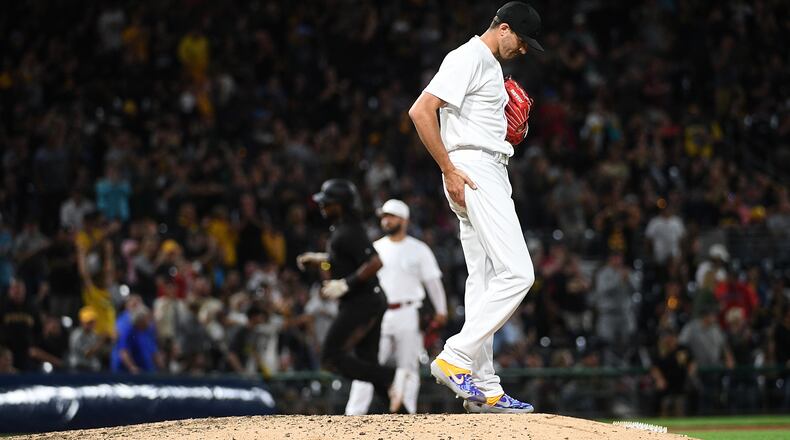 PITTSBURGH, PA - AUGUST 24: Kevin Gausman #46 of the Cincinnati Reds reacts as Josh Bell #55 of the Pittsburgh Pirates rounds the bases after hitting a three run home run to left field in the seventh inning during the game at PNC Park on August 24, 2019 in Pittsburgh, Pennsylvania. All players across MLB will wear nicknames on their backs as well as colorful, non-traditional uniforms featuring alternate designs inspired by youth-league uniforms during Players Weekend. (Photo by Justin Berl/Getty Images)