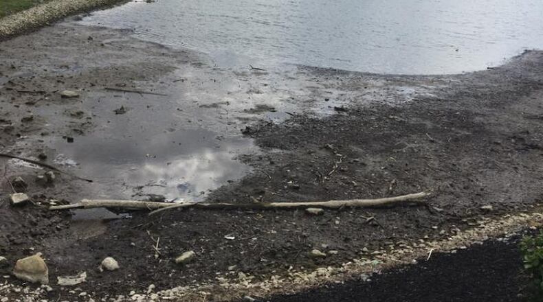 The level of Remick Lake is being lowered by two feet while litigation over who should pay for necessary improvements continues.