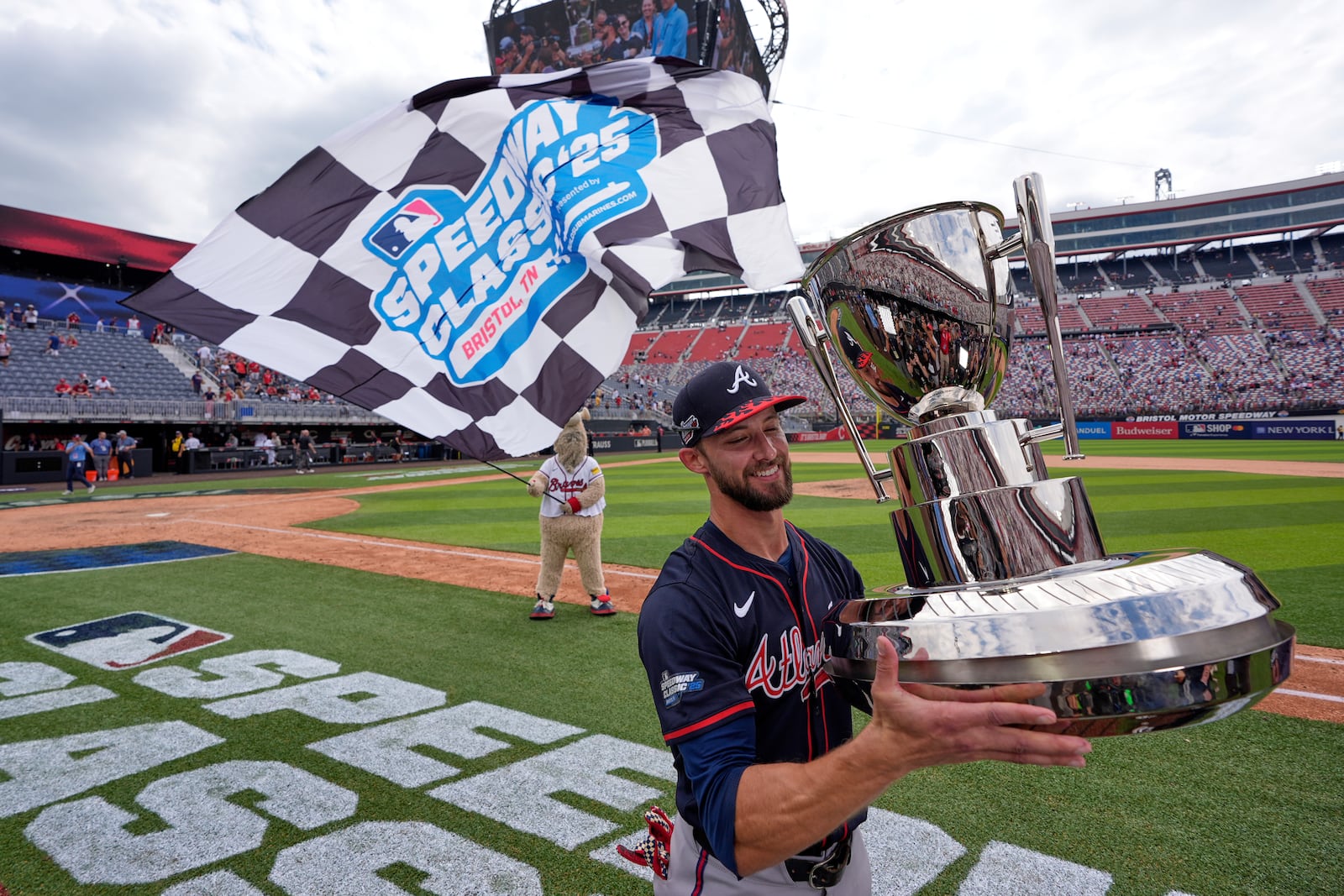 Atlanta Braves outfielder Eli White holds the trophy after their win against the Cincinnati Reds I the MLB Speedway Classic baseball game at Bristol Motor Speedway in Bristol, Tenn., Sunday, Aug. 3, 2025. Play was resumed today after yesterday's weather delay. (AP Photo/George Walker IV)