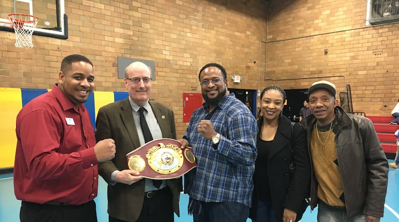Pictured (from left): Samy Broyles of the BTW Center; Hamilton Mayor Pat Moeller holding the heavyweight boxing title belt; former heavyweight boxing champion Lamon Brewster; Brewster’s wife, Juana; and Alonzo Wells, a Hamilton resident who arranged Brewster’s local visit. WAYNE BAKER/STAFF
