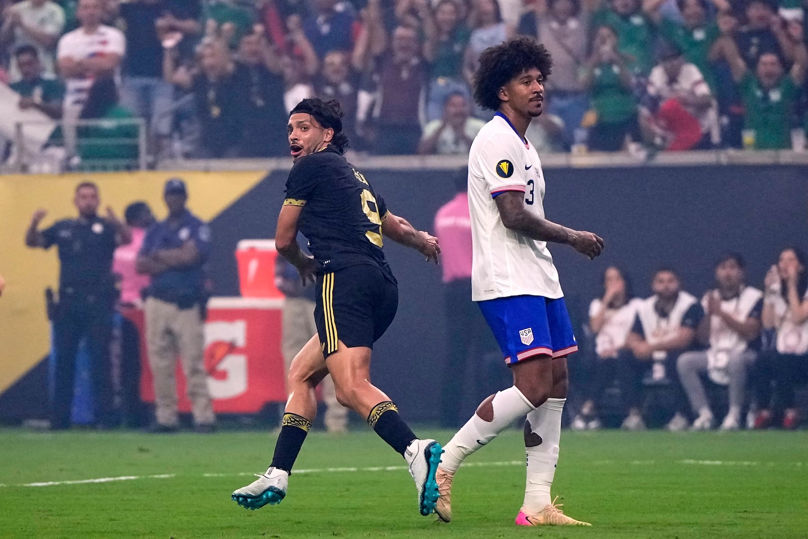 Mexico forward Raúl Jiménez (9) celebrates after scoring as he sprints past United States defender Chris Richards (3) in the first half of the CONCACAF Gold Cup final soccer match in Houston, Sunday, July 6, 2025. (AP Photo/David J. Phillip)