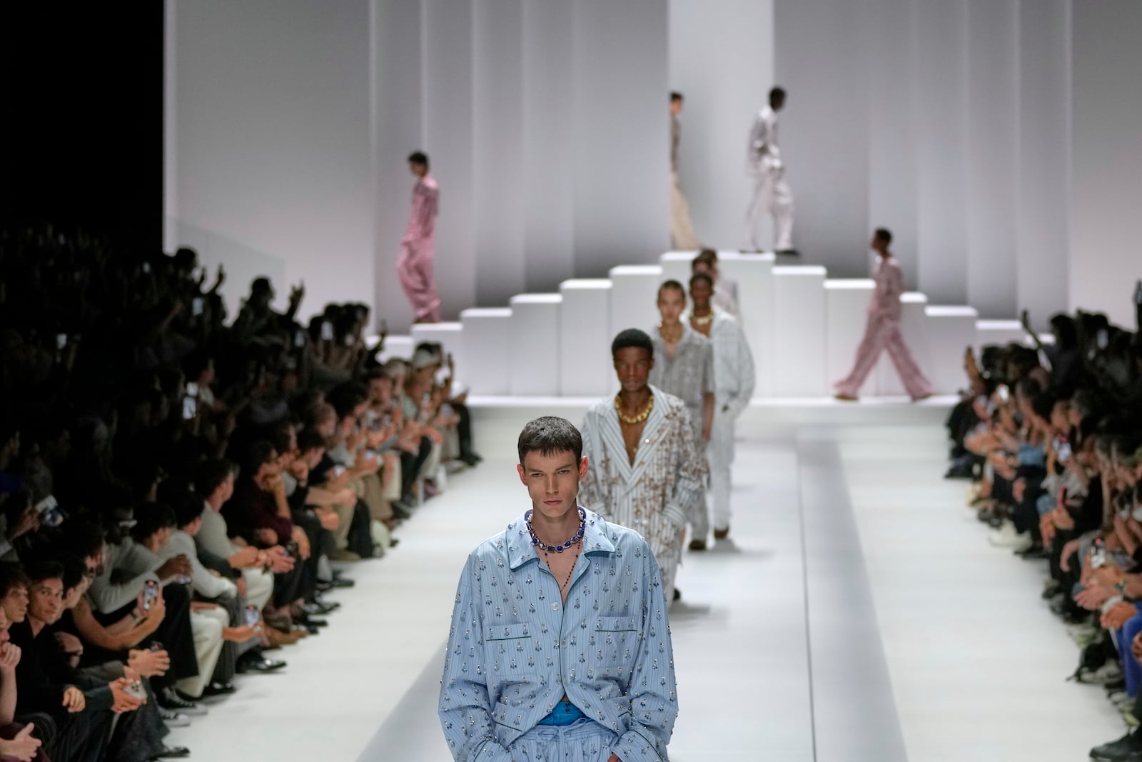 Models wear creations as part of the men's Dolce & Gabbana Spring-Summer 2026 collection, that was presented in Milan, Italy, Saturday, June 21, 2025. (AP Photo/Luca Bruno)