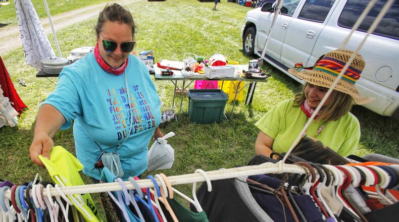 Rebekah Church, left, and Vickie Church, 12, from Cincinnati, try to find deals at the 127 yard sale Friday, Aug. 7, 2020. They went to Kentucky Thursday and plan to make is into northern Ohio today. The 127 corridor yard sale, dubbed the world's largest yard sale, is going on now through Sunday, Aug. 9 along U.S. 127 from Michigan to Alabama. This spot between New Miami and Seven Mile has multiple vendors displaying their bargains. NICK GRAHAM/STAFF