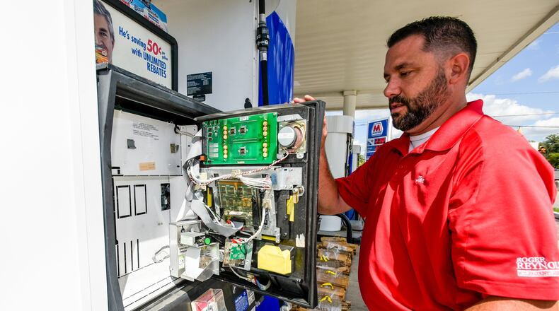 Tom Kamphaus, Consumer Services Director for Butler County Auditor’s Office, checks for credit card skimmers at the Marathon gas station at the corner of Cincinnati Dayton Road and Tylersville Road Thursday, Sept. 1, 2016 in West Chester Township. NICK GRAHAM/STAFF