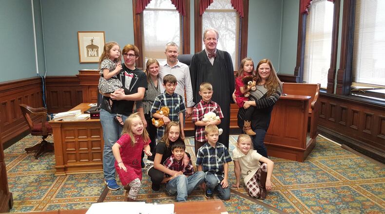 Butler County Probate Judge Randy Rogers with the Bennett family of Liberty Twp. on National Adoption Day in 2016. DENISE G. CALLAHAN/FILE