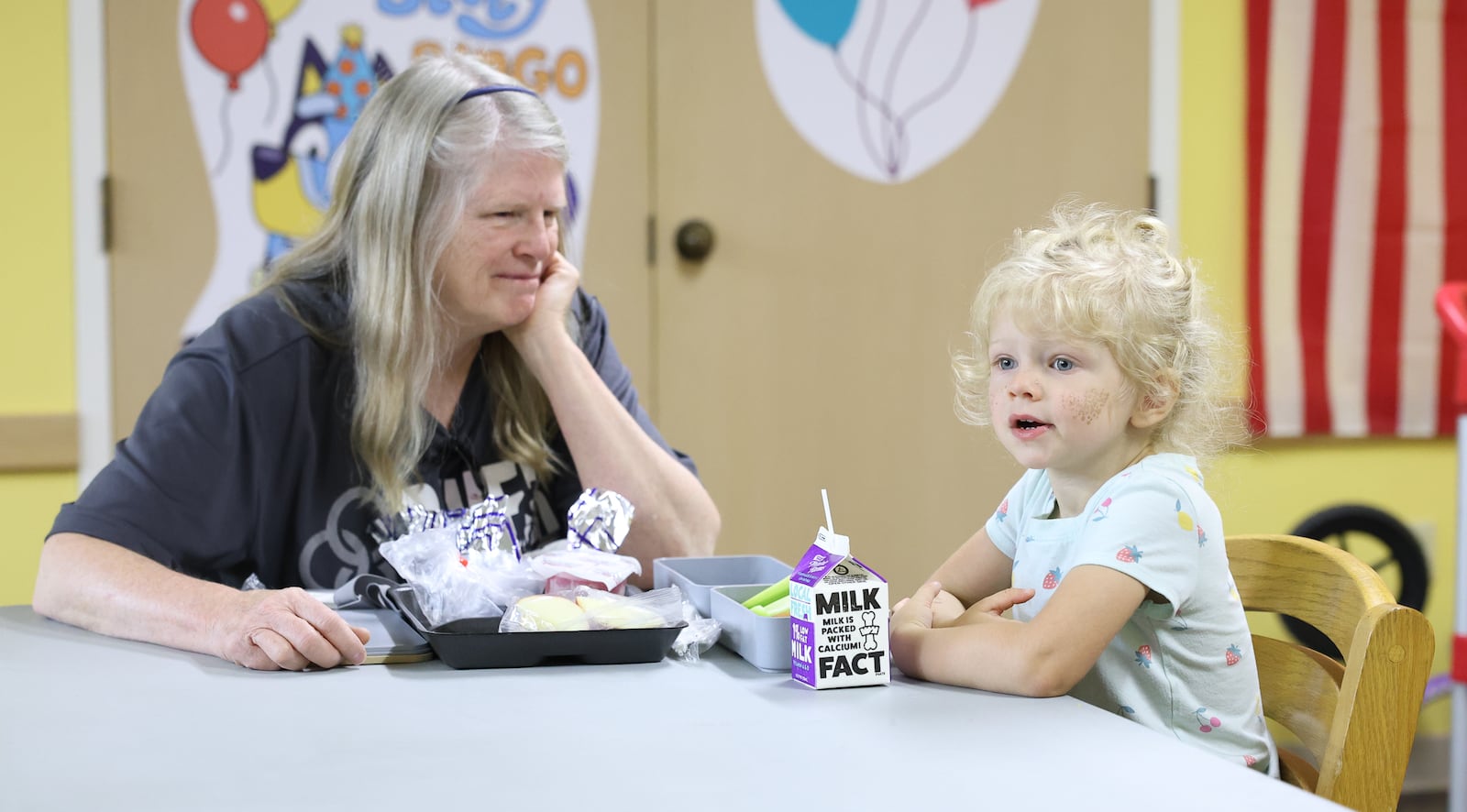 Mary watches her granddaughter Raven during a free lunch program put on by Fairborn City Schools at Fairborn Library on Friday, July 25. The school district provided lunches at 10 locations in Fairborn from June 9 to Aug. 1. Mary said she lives nearby and brought her 3-year-old granddaughter there often for socialization opportunities. Chris Burge, a child nutrition specialist at Fairborn Middle School, gave out food at the library daily and said staff are on a first-name basis with Raven. BRYANT BILLING / STAFF