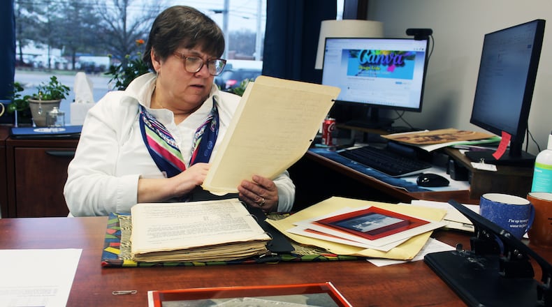 Peggy Emerson, the Fairfield Chamber of Commerce's president and chief executive officer, reviews documents and photos for inclusion in a display celebrating the chamber's 70th anniversary. CONTRIBUTED/SUE KIESEWETTER