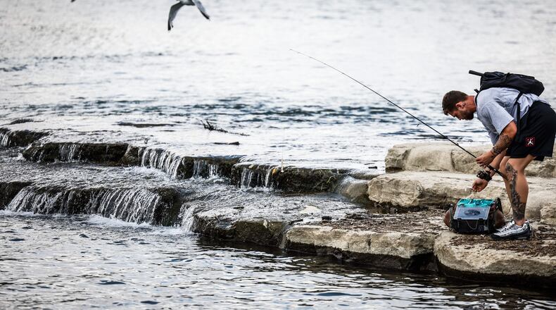 George Thomas, from Fairfield Ohio, fishes on the Great Miami River near RiverScape Metro Park Wednesday August 17, 2022. Scientist believe in 30 years Southwestern Ohio will be in the "Extreme Heat Belt," which will effect the way we work and play. JIM NOELKER/STAFF