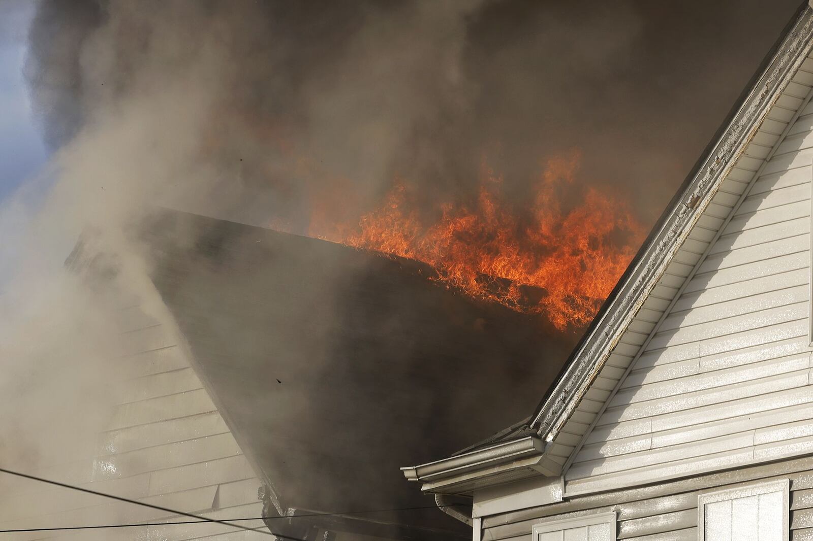 Multiple callers reported a Hanover Street house fire on Friday afternoon, Nov. 18, 2022, in Hamilton. NICK GRAHAM/STAFF