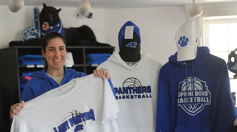 Deanna Bonilla. manager of the Fan Store in Springboro holds up a Lady Panther basketball T-shirt Wednesday, March 13, 2024. The Springboro Lady Panthers are playing in the state final four for the first time Friday, March 15, 2024. The Fan Store is located at 205 N. Main Street. MARSHALL GORBY\STAFF