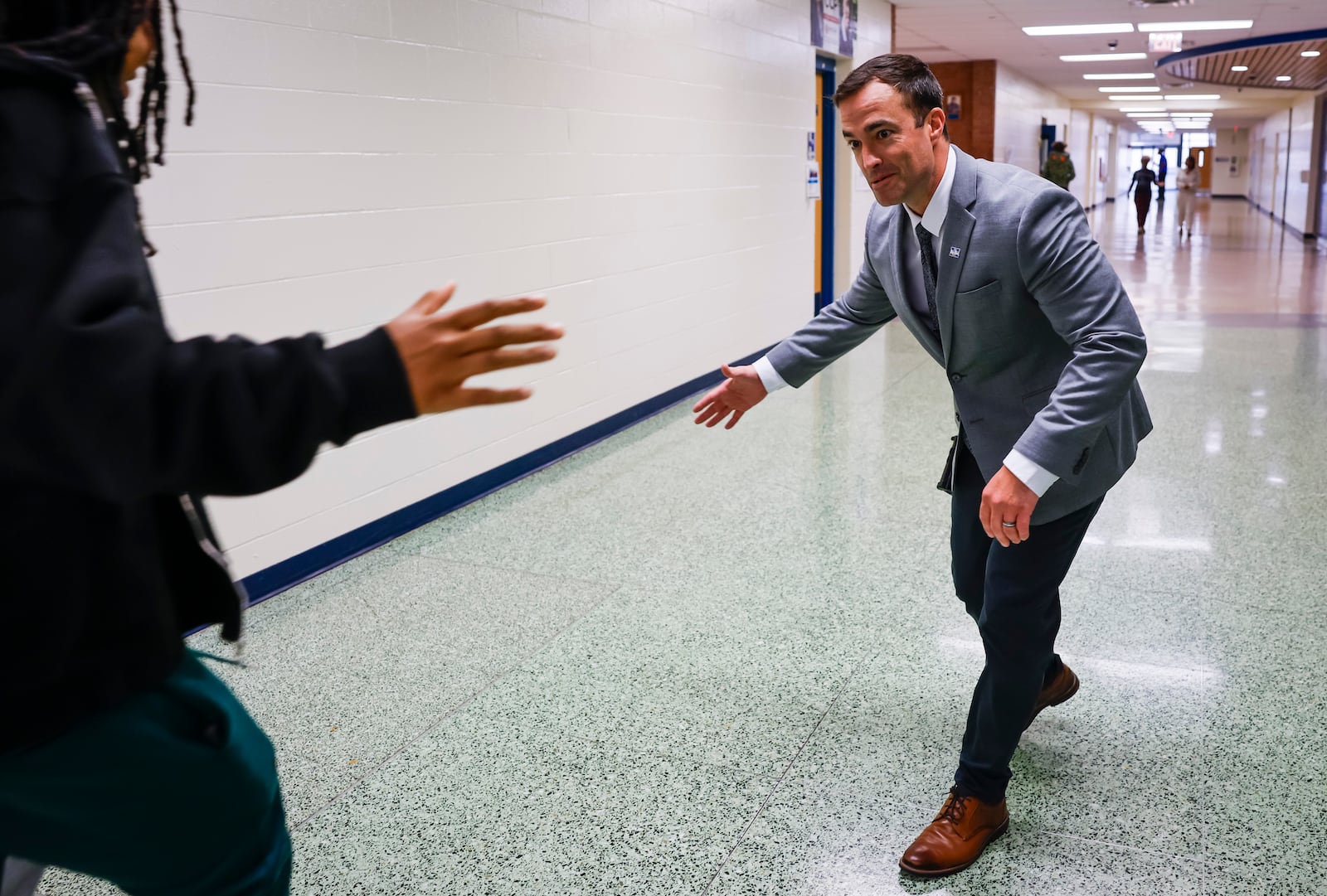 New Hamilton High School Principal Ty Smallwood greets students in the hallway Thursday, Sept. 4, 2025 in Hamilton. He has served as principal at Highland Elementary and Hamilton Freshman School. NICK GRAHAM/STAFF