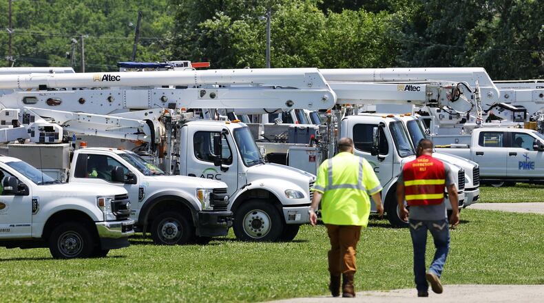 Electric service crews stage to help Duke Energy crews at Butler County Fairgrounds Tuesday, June 14 in Hamilton after storms damaged trees and knocked down power lines last night. NICK GRAHAM/STAFF
