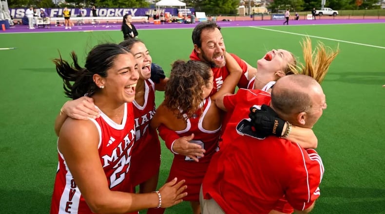 Miami field hockey coach Iñako Puzo (far back) celebrates with his team last season. MIAMI ATHLETICS PHOTO