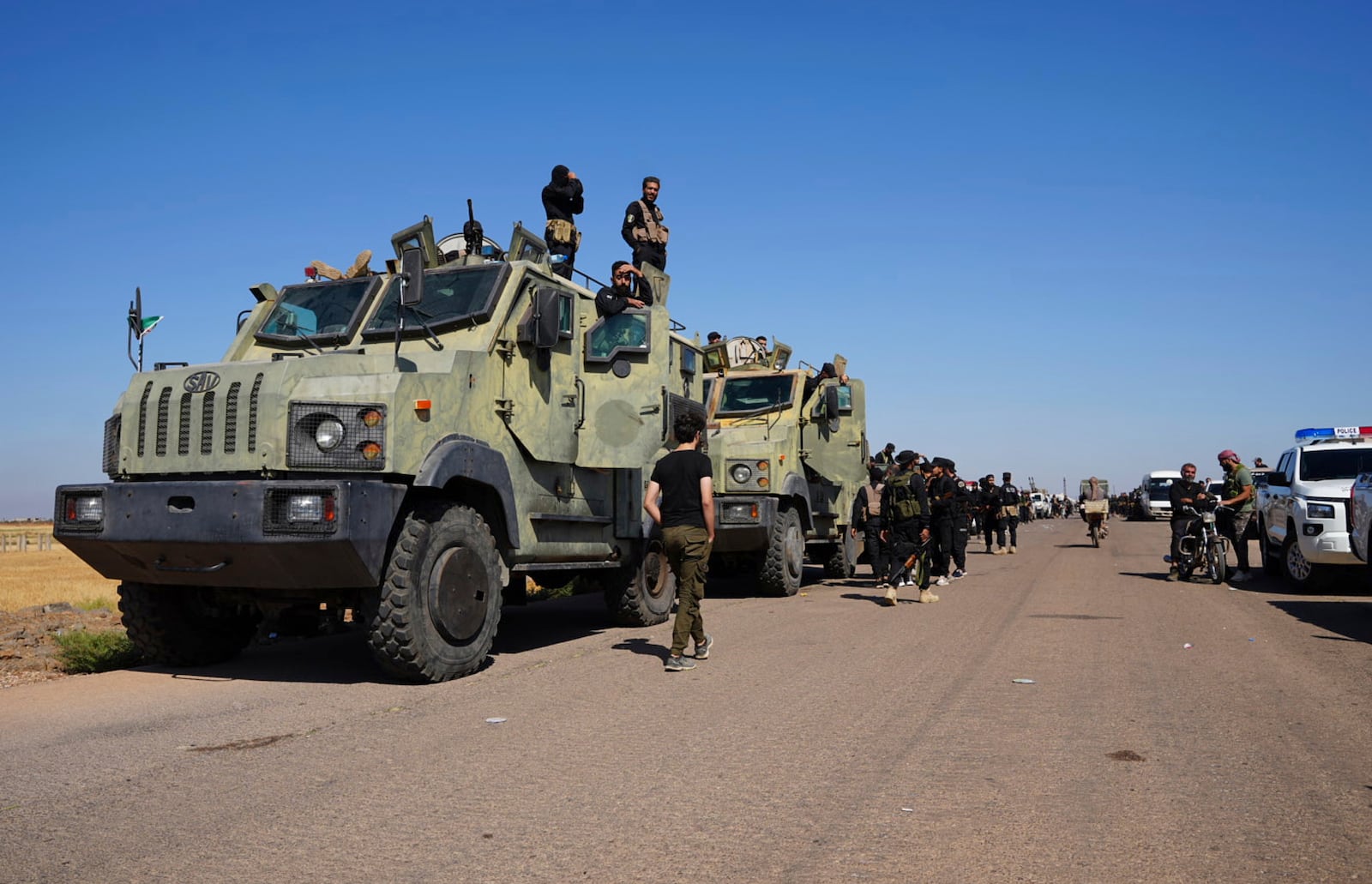 Syrian government security forces gather on the outskirts of Sweida province where clashes erupted between Druze militias and Sunni Bedouin clans, southern Syria, Monday, July 14, 2025. (AP Photo/Malek Khattab)