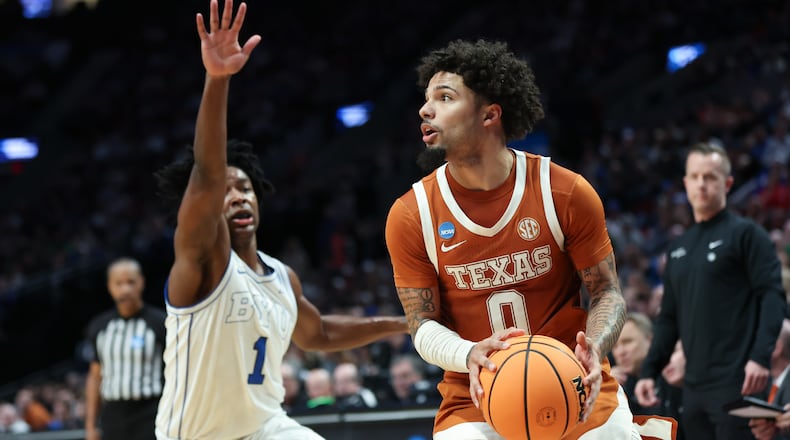 Texas guard Jordan Pope (0) looks to shoot as BYU guard Robert Wright III (1) defends during the first half in the first round of the NCAA college basketball tournament Thursday, March 19, 2026, in Portland, Ore. (AP Photo/Amanda Loman)