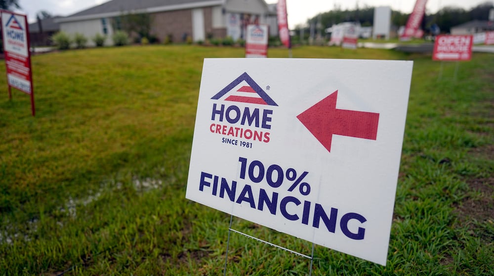 FILE - A sign promoting 100% financing is displayed outside a model home in the Colony Ridge development in Cleveland, Tx., Oct. 3, 2023. (AP Photo/David J. Phillip, File)