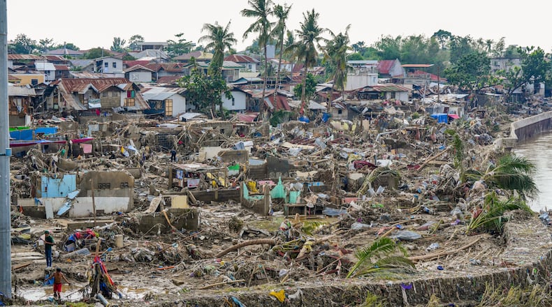 In this photo provided by the Malacanang Presidential Communications Office, damaged homes beside Mananga Bridge in Talisay, Cebu Province, central Philippines on Friday Nov. 7, 2025 after Typhoon Kalmaegi devastated the province and claimed lives. (Malacanang Presidential Communications Office via AP)