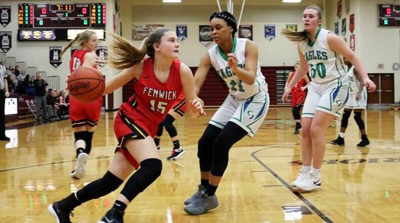 Fenwick’s Hannah Beckman (15) drives on Chaminade Julienne’s Teri McCann (11) on Saturday afternoon at Lebanon. Fenwick won the Division II sectional opener 38-35. CONTRIBUTED PHOTO BY TERRI ADAMS