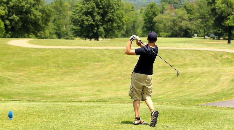 A golfer tees of at Twin Run golf course in Hamilton. Rates are dropping at Twin Run golf course as an incentive for players to check out the course. STAFF FILE PHOTO