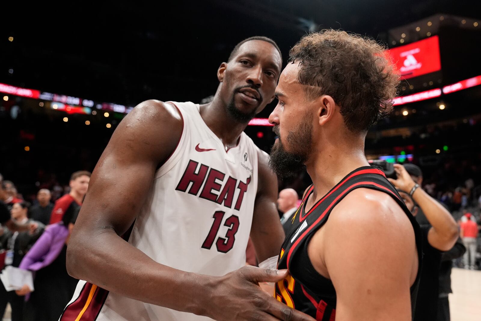 Miami Heat center Bam Adebayo (13) and Atlanta Hawks guard Trae Young (11) meet after an NBA play-in tournament basketball game, Friday, April 18, 2025, in Atlanta. (AP Photo/Brynn Anderson)