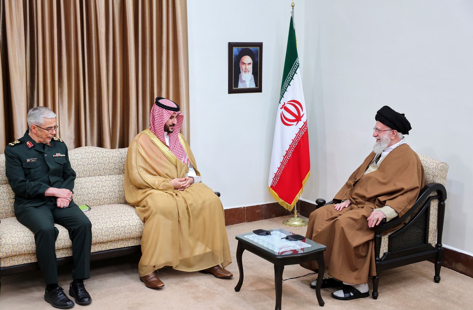In this photo released by an official website of the office of the Iranian supreme leader, Supreme Leader Ayatollah Ali Khamenei, right, listens to Saudi Arabia's Defense Minister Prince Khalid bin Salman, center, as Chief of the General Staff of Iran's Armed Forces Gen. Mohammad Hossein Bagheri attends their meeting in Tehran, Iran, Thursday, April 17, 2025. (Office of the Iranian Supreme Leader via AP)