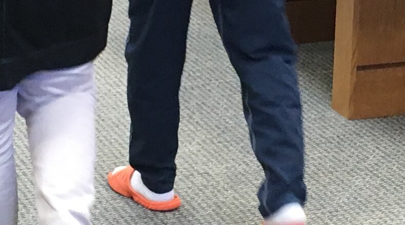 A Middletown High School sophomore, 15, is led out of Juvenile Court Tuesday morning after he pleaded “true” to aggravated assault. He later was released to his parents. RICK McCRABB/STAFF