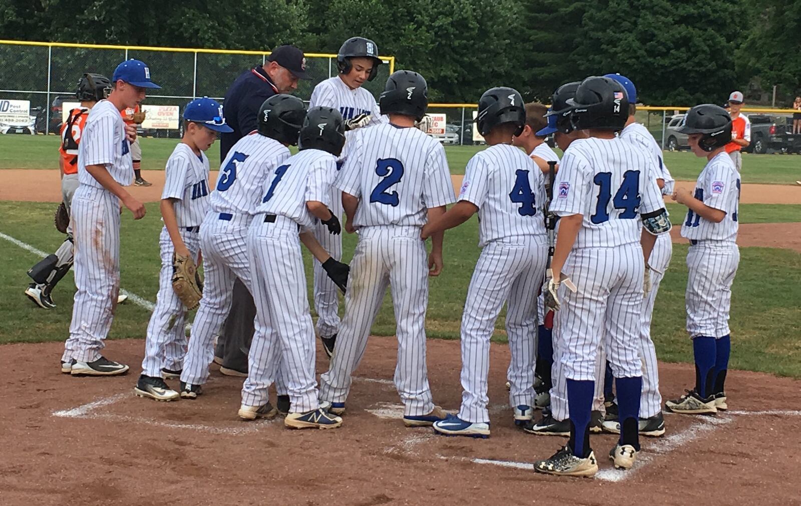 Hamilton’s Ethan Stone jumps onto home plate after his second-inning home run Thursday night in the Ohio Little League Tournament at the Hoover Community Recreation Complex in North Canton. Stone had seven RBIs in the 15-1 victory over Galion. RICK CASSANO/STAFF