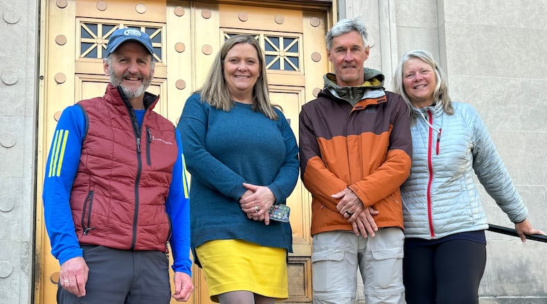 Pictured are Ron (center right) and Joy (right) McAdams with Great Miami Riverway Manager Dan Foley (left) and Miami Conservancy District General Manager Mary Lynn Lodor outside the Conservancy District's offices in downtown Dayton. The McAdams' made a stop to visit the district during their 8-day trek along the nearly 100-mile Great Miami River Trail at the end of March 2024. PROVIDED