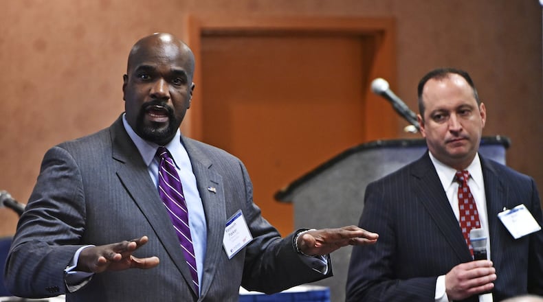 Kenneth L. Parker, Criminal Division Chief, U.S. Attorney’s Office Southern District of Ohio, speaks during the Regional Drugged Driving Summit hosted by AAA and the Ohio Department of Public Safety with Butler County Assistant Prosecutor Brad Burress, right, discussing the effects of the issue locally and in Ohio. NICK GRAHAM/STAFF