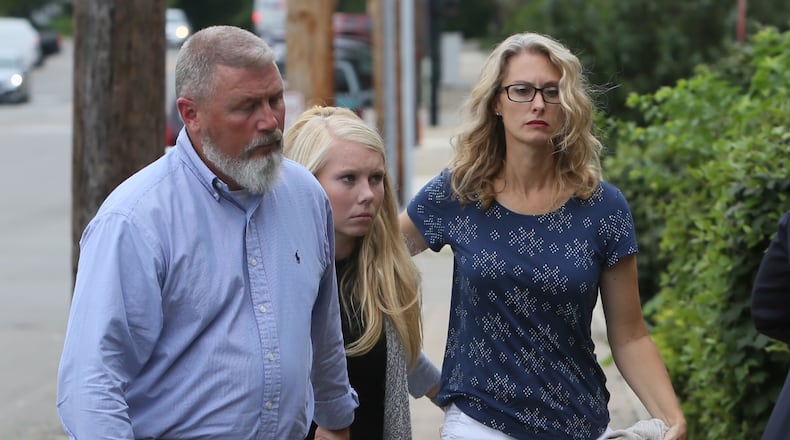 Brooke Skylar Richardson, center, is escorted by her parents Friday into Franklin Municipal Court for an arraignment hearing on a charge of reckless homicide in connection to the death of her baby. The baby’s remains were found buried in the backyard of her home. GREG LYNCH/STAFF