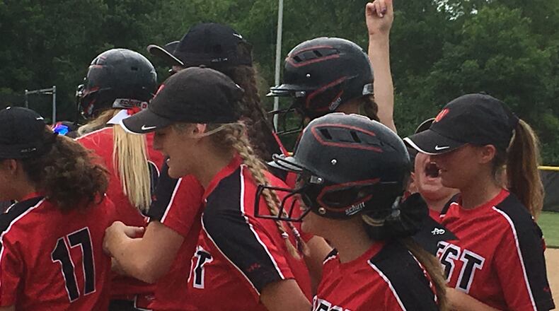 The No. 1 sign goes up in the Lakota West celebration after Alyssa Triner’s two-run homer in the seventh inning of Saturday’s Division I regional final against Lebanon at Lakota West. RICK CASSANO/STAFF