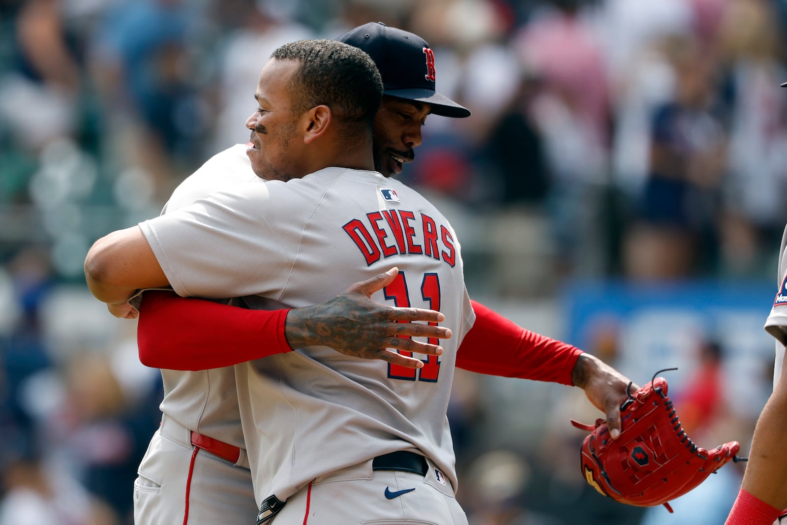 Boston Red Sox pitcher Aroldis Chapman celebrates with Rafael Devers (11) after their win over the Atlanta Braves in a baseball game, Sunday, June 1, 2025, in Atlanta. (AP Photo/Butch Dill)