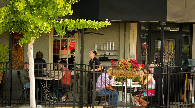 Outdoor dining at the Caroline restaurant in downtown Troy provides a view of the fountain and activity on the square. JIM WITMER / STAFF