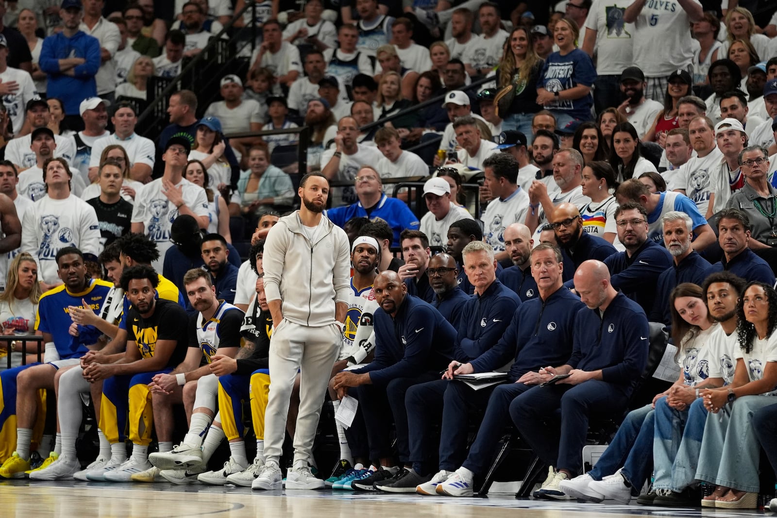 Golden State Warriors guard Stephen Curry (30) looks on near the bench during the second half of Game 5 of an NBA basketball second-round playoff series against the Minnesota Timberwolves, Wednesday, May 14, 2025, in Minneapolis. (AP Photo/Abbie Parr)