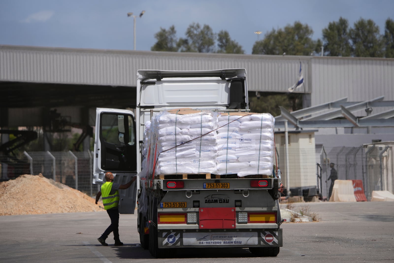 Trucks carrying humanitarian aid for the Gaza Strip are seen at the Kerem Shalom Crossing in southern Israel, Monday, May 19, 2025. A day after Israel said it would resume allowing aid into the territory. (AP Photo/Ohad Zwigenberg)
