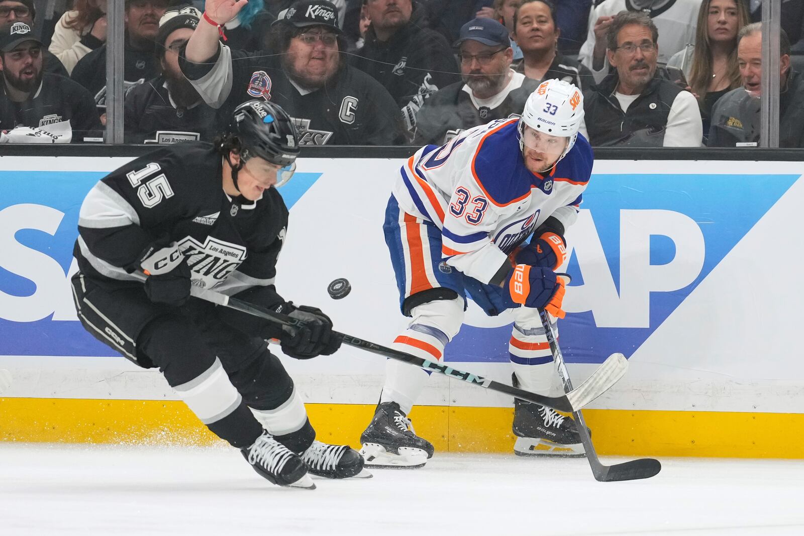 Los Angeles Kings center Alex Turcotte, left, and Edmonton Oilers left wing Viktor Arvidsson vie for the puck during the first period in Game 1 of an NHL hockey first-round playoff series Monday, April 21, 2025, in Los Angeles. (AP Photo/Mark J. Terrill)